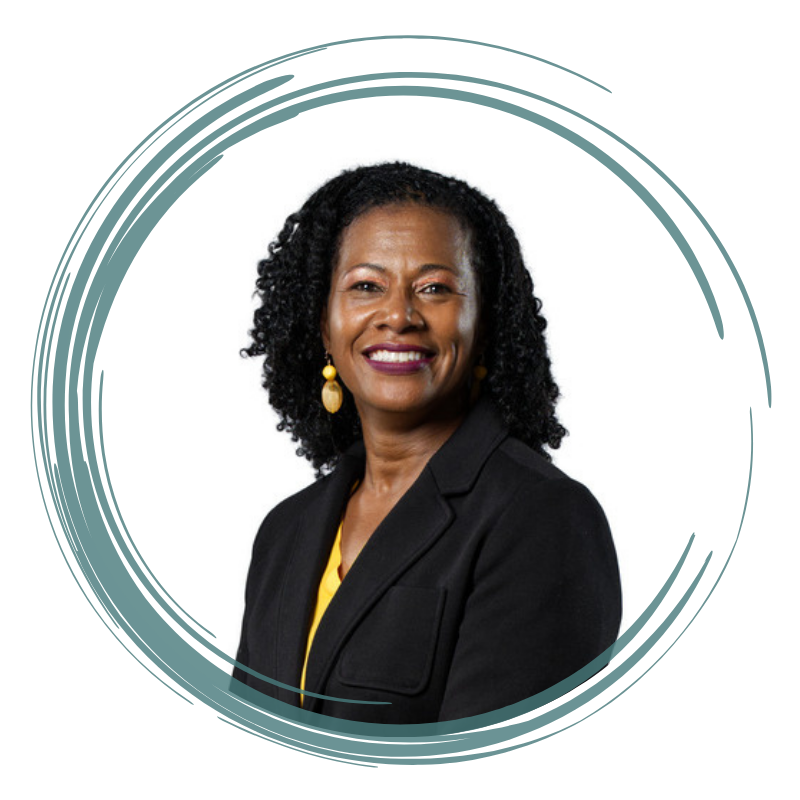 Portrait of Casidy Sanders with curly hair, smiling warmly, wearing a black blazer over a yellow blouse, accessorized with yellow earrings. The image is encircled by a stylized teal and white circular frame.